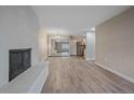Bright living room with modern flooring, brick fireplace and mirrored closet doors at 4110 Hale Pkwy # 1E, Denver, CO 80220