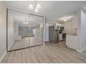 Spacious living room featuring a fireplace, modern lighting, and a large mirrored closet at 4110 Hale Pkwy # 1E, Denver, CO 80220