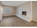 Living room with fireplace and wood-look floors at 4110 Hale Pkwy # 1E, Denver, CO 80220