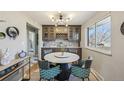 Elegant dining area with a marble table, custom cabinetry, and a modern light fixture at 1634 S Yukon Ct, Lakewood, CO 80232