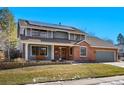 Two-story home with brick and siding, solar panels, and a landscaped yard at 1640 W 113Th Ave, Denver, CO 80234