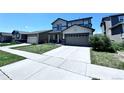 Two-story home with an attached garage, well-maintained lawn, and a concrete driveway, situated in a suburban neighborhood at 9923 Truckee St, Commerce City, CO 80022