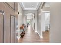Inviting entryway featuring wood floors, neutral walls, and an arched doorway leading to other parts of the home at 11865 Barrentine Loop, Parker, CO 80138