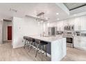 Modern kitchen with stainless steel appliances, a large marble island, and stylish pendant lighting at 1700 Bassett St # 101, Denver, CO 80202