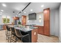 Open concept kitchen with an island, bar seating, and stainless steel appliances at 30938 Niakwa Rd, Evergreen, CO 80439