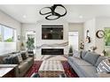 Bright living room with a modern fireplace, large TV, and comfortable seating at 2635 Pierce St, Wheat Ridge, CO 80214