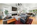 Stylish living room featuring a modern fireplace, large windows, and hardwood floors at 2635 Pierce St, Wheat Ridge, CO 80214