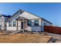 House exterior with gray accents, walkway, and wood fence at 2937 Pershing St, Strasburg, CO 80136