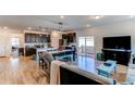 Open living space with hardwood floors and a modern aesthetic at 2937 Pershing St, Strasburg, CO 80136
