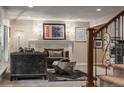 Comfortable living room area with a fireplace and staircase leading to other parts of the home at 7750 S Glencoe Way, Centennial, CO 80122