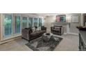 Comfortable living room showcasing neutral paint, fireplace, shuttered windows, and plush seating at 7750 S Glencoe Way, Centennial, CO 80122