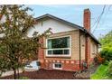 A charming brick home with a large window and neat landscaping at 1463 Dahlia St # 2, Denver, CO 80220