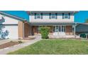 Close-up of a well-maintained front yard with a charming walkway leading to the front door at 6621 S Cherry Way, Centennial, CO 80121