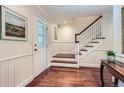 Bright foyer with hardwood floors, elegant staircase, and decorative details at 10130 E Powers Ave, Greenwood Village, CO 80111