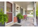 Inviting front porch with seating, a well-maintained entrance, and lovely plants at 10130 E Powers Ave, Greenwood Village, CO 80111