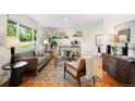 Bright living room features wood floors, a large window, and stylish furnishings at 9325 Meade St, Westminster, CO 80031