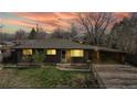 Brick ranch home with carport, lit at night at 1242 Elder St, Denver, CO 80221