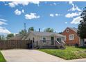 Exterior view of home featuring a cute front deck and driveway at 3134 W Center Ave, Denver, CO 80219