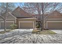 Inviting townhome featuring a two-car garage and well-maintained landscaping at 6004 W Colorado Ln, Lakewood, CO 80232