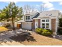 Two-story home with brick accents, an attached two-car garage, and a well-manicured lawn at 3819 S Waco St, Aurora, CO 80013