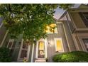 Charming townhome with a well-maintained front yard and inviting entrance with warm lights at 10819 Summerset Way, Parker, CO 80138