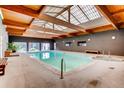 Bright indoor pool with skylights, light stone and wood accents at 8824 E Florida Ave # 103, Denver, CO 80247