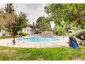 Inviting outdoor pool area with landscaping and lounge chairs at 8824 E Florida Ave # 103, Denver, CO 80247