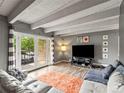 Bright living room with stylish furnishings, recessed lighting, and access to the outdoor balcony at 100 S Clarkson St # 202, Denver, CO 80209