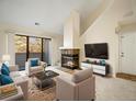 Inviting living room featuring a fireplace, plush seating, and a sliding glass door to the outside at 3600 S Pierce St # 5-204, Denver, CO 80235