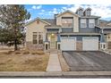 Charming townhome with a stone facade, attached garage, and well-maintained landscaping in a desirable neighborhood at 4674 Flower St, Wheat Ridge, CO 80033