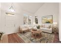 Cozy living room with vaulted ceilings, natural light, and modern decor provides a welcoming space for relaxation at 4674 Flower St, Wheat Ridge, CO 80033