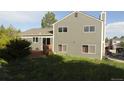 View of the backyard featuring a two-story home with a wooden deck at 6815 Hills Dr, Parker, CO 80138