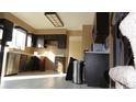 Kitchen with dark wood cabinets and stainless steel appliances at 6815 Hills Dr, Parker, CO 80138