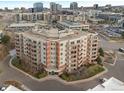 Aerial view of a modern apartment building with ample parking at 4875 S Monaco St # 408, Denver, CO 80237