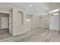 Open concept living room with wood floors and recessed lighting at 14308 E Whitaker Pl # 114, Aurora, CO 80015