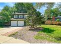 Charming two-story home with a two car garage, well-manicured lawn and mature trees at 2211 Sherman St, Longmont, CO 80501