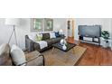 Cozy living room featuring hardwood floors, a comfortable sofa, and stylish decor at 4740 Milwaukee St, Denver, CO 80216