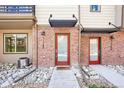 Townhome entrance with red front door and decorative rock landscaping at 11142 Bella Vita Dr, Broomfield, CO 80020