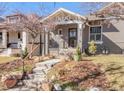 Traditional home with a brick facade, front porch, and classic architectural details with landscaped front yard at 543 N Marion St, Denver, CO 80218