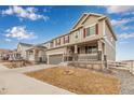 Charming two-story home with a covered front porch and well-manicured lawn in a peaceful neighborhood at 3659 Makley Cir, Castle Rock, CO 80104