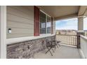 Cozy front porch with decorative stone accents, seating, and a lovely view of the surrounding neighborhood at 3659 Makley Cir, Castle Rock, CO 80104