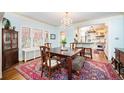 Bright dining room features a chandelier, large table, and opens to the kitchen at 615 N Williams St, Denver, CO 80218