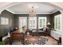 Well-lit office features a stylish chaise lounge, elegant chandelier, and classic shuttered windows at 615 N Williams St, Denver, CO 80218