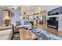 Open-concept living room showcasing hardwood floors, and a view into the kitchen at 20040 E Doane Dr, Aurora, CO 80013