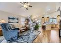 Bright living room featuring wood floors, vaulted ceilings, neutral walls, and stylish furnishings at 20040 E Doane Dr, Aurora, CO 80013