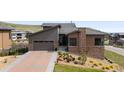 Charming single-Gathering home with a two-car garage, stone accents, and professionally landscaped yard at 10869 Bluffside Dr, Lone Tree, CO 80124
