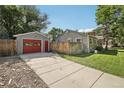 View of detached garage, driveway and fenced yard at 1975 Cody St, Lakewood, CO 80215