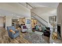 Bright living room features a fireplace, hardwood floors, stairs to second story and neutral paint colors at 701 Harlan St # E72, Lakewood, CO 80214