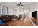 Cozy living room features a fireplace, ceiling fan and hardwood floors at 3734 Ridgeway St, Boulder, CO 80301