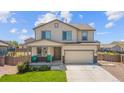 Charming two-story home showcasing a well-maintained lawn, inviting porch, and an attached two-car garage at 47300 Clover Ave, Bennett, CO 80102